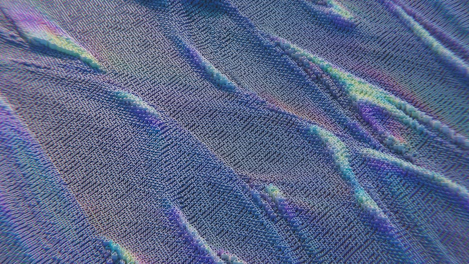 Colorful abstract pattern resembling digital waves with intricate texture in blue and purple hues.