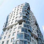 Striking modern architecture of a building in London with clear blue sky.