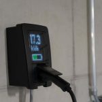 Detailed view of an electric vehicle charging station indoors, showcasing charging technology.