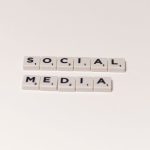 Scrabble tiles spelling 'social media' on a white background, representing digital communication concepts.