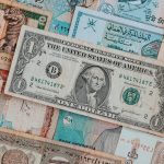 Top view of assorted paper money with American greenback representing image of President and numbers with words and signature on bill