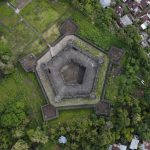 A striking aerial view of Fort Belgica, showcasing its geometric design amidst green surroundings.