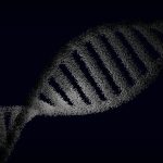 Artistic rendering of a DNA strand with particle effects against a dark background.