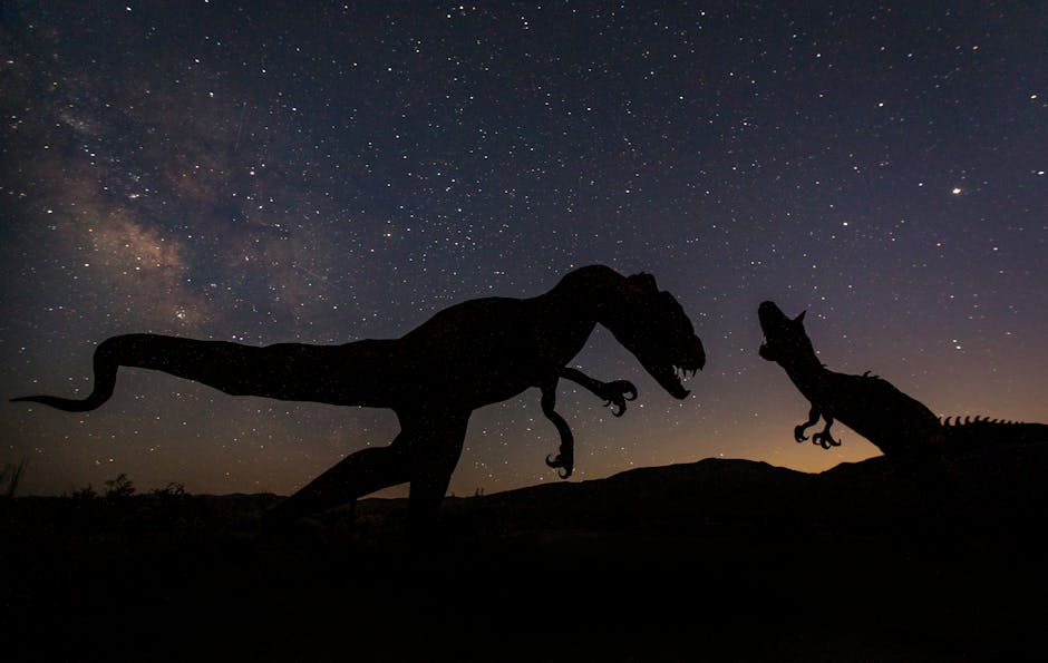 Dinosaur silhouettes against a star-filled night sky create a prehistoric ambiance.