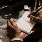 A detective decoding cipher documents with a magnifying glass, notebook in hand.