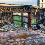 Drone shot of a fire-damaged building in Banten, Indonesia showing twisted metal and rubble.