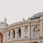 Elegant architecture featuring a dome and arches, with intricate sculptures and statues.