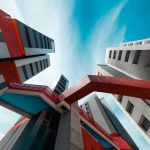 Impressive modern building with vibrant colors and geometric shapes against a blue sky.
