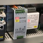 Close-up of electronic components and wires inside industrial equipment.