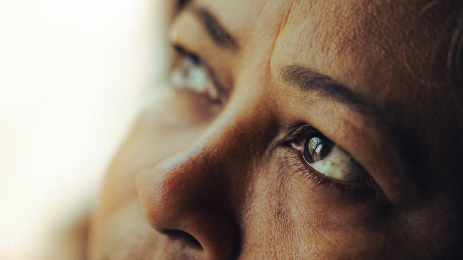 Intimate close-up shot of a woman's eyes reflecting deep thought and emotion.