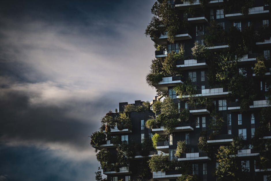 Innovative green architecture featuring lush plants growing on a modern urban skyscraper facade.