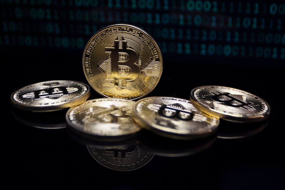 Close-up of gold Bitcoin coins against a digital binary code background, symbolizing modern finance.