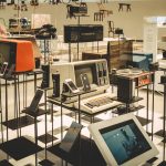 Showcase of vintage electronics in a modern museum setting.