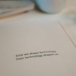 Open book with quote on technology's influence, perfect for tech inspiration.