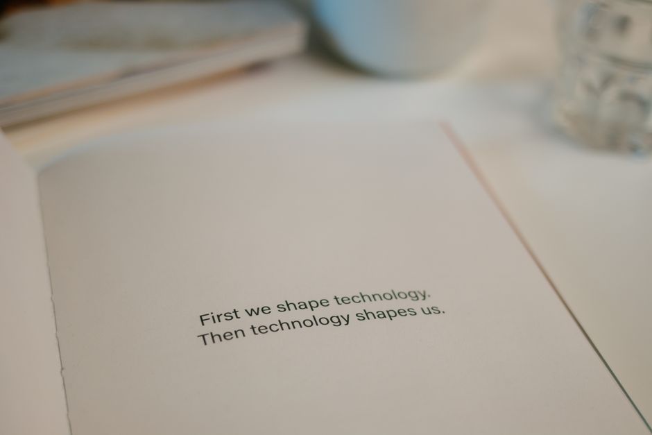 Open book with quote on technology's influence, perfect for tech inspiration.