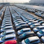 From above of many rows with prestige modern shiny automobiles of manufacture in daytime