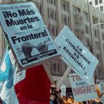 Protesters in Los Angeles rally for immigration rights with powerful messages on signs.