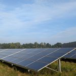 Solar panels in a Ratzeburg field, capturing renewable energy on a clear day.