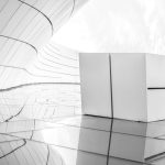 Sleek futuristic architecture in black and white with reflective surfaces.