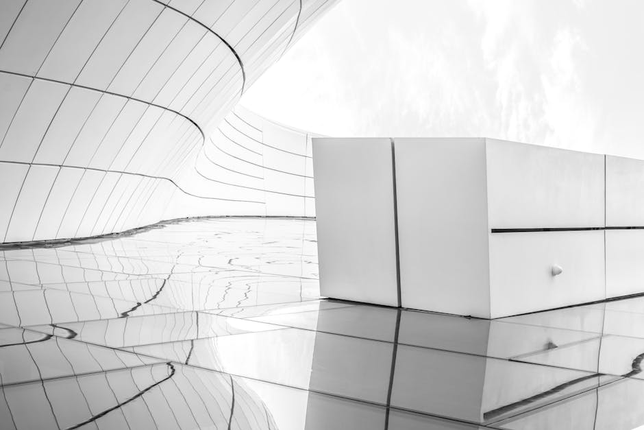 Sleek futuristic architecture in black and white with reflective surfaces.