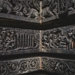 Close-up of ancient stone carvings depicting historical and mythical scenes.