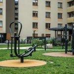 Modern outdoor gym equipment in a residential courtyard, promoting fitness and healthy lifestyle.