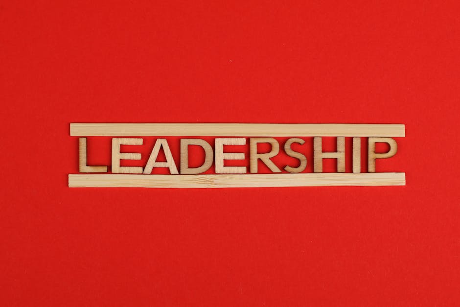 Wooden letters spelling leadership on a vibrant red background, conveying bold concepts.